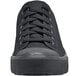 A close up of a black Shoes For Crews Delray sneaker with laces.