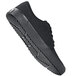 A black Shoes For Crews Merlin casual shoe with a rubber sole.