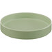 A round green melamine plate with a raised rim.