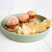 A Cal-Mil Hudson matcha melamine plate with three mini sliders and chips.