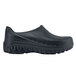 A black Shoes For Crews unisex work shoe with rubber soles.