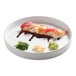 A Cal-Mil white melamine plate with sushi and sauce.