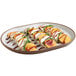 A Cal-Mil stoneware oval platter with sliced peaches and cream cheese on it.