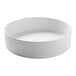 A white Cal-Mil stackable melamine bowl.