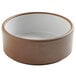 A brown stoneware ramekin with a white rim.