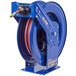 A blue Coxreels truck mount hose reel with a blue hose attached.