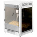 A white Paragon popcorn machine with a glass container of popcorn inside.