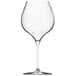 A close-up of a clear Chef & Sommelier Burgundy wine glass with a stem.