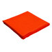 An orange Intedge rectangular cloth table cover folded up.