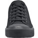 A close up of a black Shoes For Crews Delray sneaker with laces.