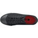 A black Shoes For Crews Delray non-slip shoe with a red sole.