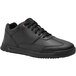 A black Shoes For Crews women's athletic shoe with laces.
