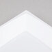 A close up of a white rectangular object with a grey surface.