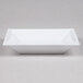 A white rectangular WNA Comet plastic bowl with a lid.