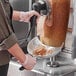 A person using a Choice aluminum gyro catch pan to fill meat.