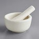 A white Fox Run porcelain mortar and pestle set.