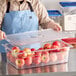 a group of apples in a glass container