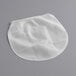A white mesh bag for a Fox Run jelly and jam strainer.