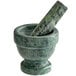 A Fox Run green marble mortar and pestle on a counter.