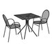 A Lancaster Table & Seating Harbor black metal table with 2 chairs on a patio.