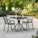 A Lancaster Table and Seating outdoor table and chairs on a patio.