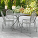 A Lancaster Table & Seating Harbor Gray outdoor patio table with modern legs and four chairs.