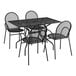 A Lancaster Table & Seating black metal rectangular outdoor table with modern legs and four arm chairs.