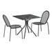 A Lancaster Table & Seating Harbor black metal table with modern legs and two side chairs.