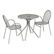A Lancaster Table & Seating Harbor Gray round metal table with modern legs and 2 arm chairs.