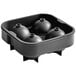 A black silicone ice mold with four round spheres.