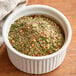 A bowl of Regal Hot Italian Seasoning on a table.