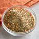 A bowl of spices and herbs on a table.