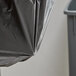 A black Lavex Hercules trash bag in a trash can.