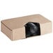 a cardboard box with black garbage bags inside