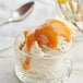 A glass bowl of ice cream with J. Hungerford Smith caramel fudge topping.