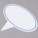 A white oval sign with blue lines.