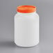 a white plastic container with orange lid