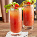 Two glasses of bloody marys with Ruby Kist Tomato Juice, pickles, and olives.