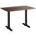 A Lancaster Table & Seating rectangular dining height outdoor table with a textured brown top and black legs.