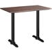 A Lancaster Table & Seating rectangular counter height table with a dark wood top and black legs.