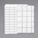 A stack of Monarch Brands white and grey windowpane patterned kitchen towels.