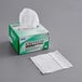 A white box of Kimtech Kimwipes with a white tissue paper on it.
