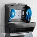 A black and blue Lavex Select auto paper towel dispenser on a wall.