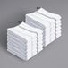 A stack of white towels with gray stripes.