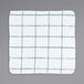 A white terry dish cloth with green windowpane lines.