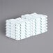 A stack of Monarch Brands green windowpane pattern towels with white stripes.