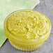 A bowl of American Almond Pistachio Paste on a table with a green cloth.