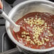 A spatula stirring Cacao Barry cocoa butter into chocolate.