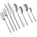 A close-up of several Acopa Petra stainless steel dinner/dessert spoons.