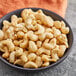 A bowl of Regal raw cashews on a table.